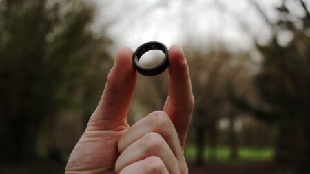 smart ring held up forest background